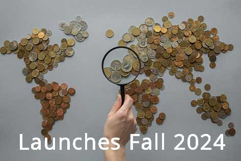 coins laid out like a flat map of the world behind a hand holding a magnifying glass 