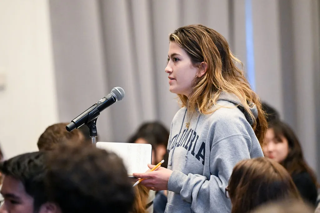 Woman from the audience asking a question