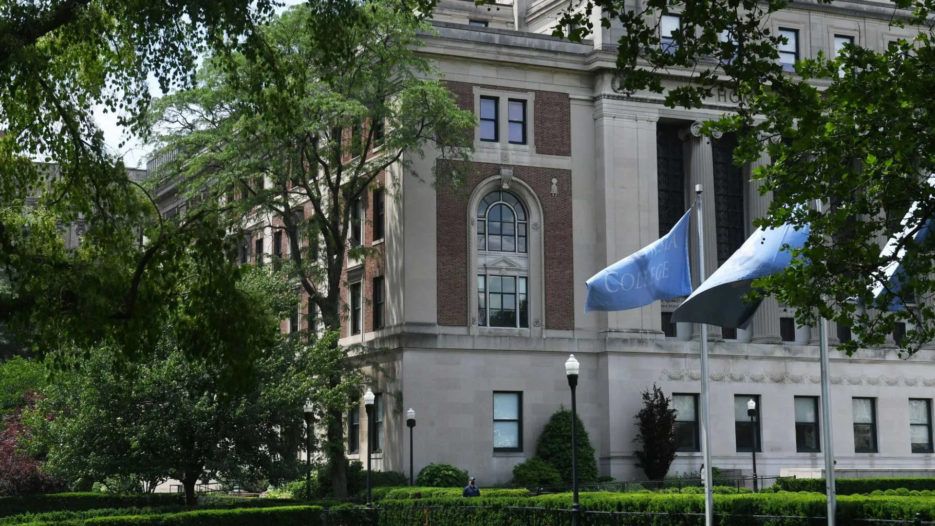 columbia library behind trees and flags